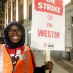 A striker smiles outside Marriott's Westin Book Cadillac in Detroit