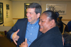 A Hilton employee poses for a photo with Senator Mark Begich in the employee cafeteria.
